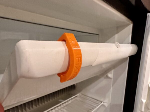 IFIXIFI airing clip installed on freezer door flap – keeps freezer aired out and gasket protected